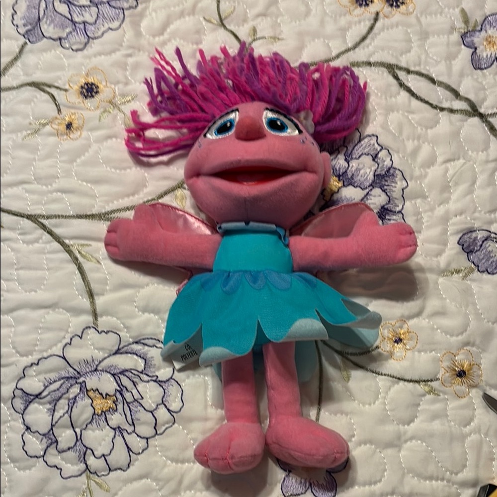 Sesame Street Pink and Teal Stuffed Toy- with pink angel wings.